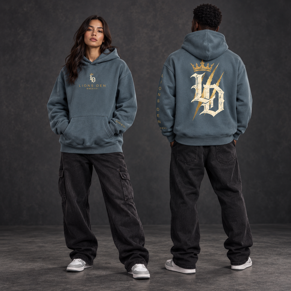 Two models wearing the Gray Blue Lions Den Crowned Gothic LD oversized fleece hoodie, shown from the front and back
