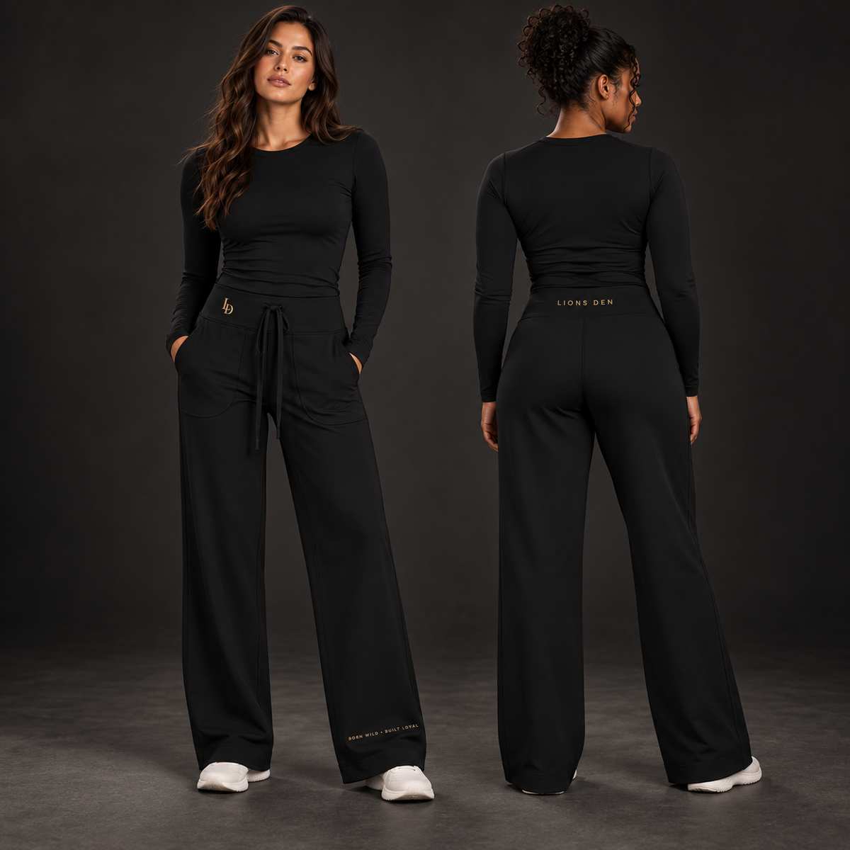 Two women model the black Lions Den MMXXVI straight-leg yoga pants, showing the LD hip mark, lower-leg motto, and back waistband wordmark.