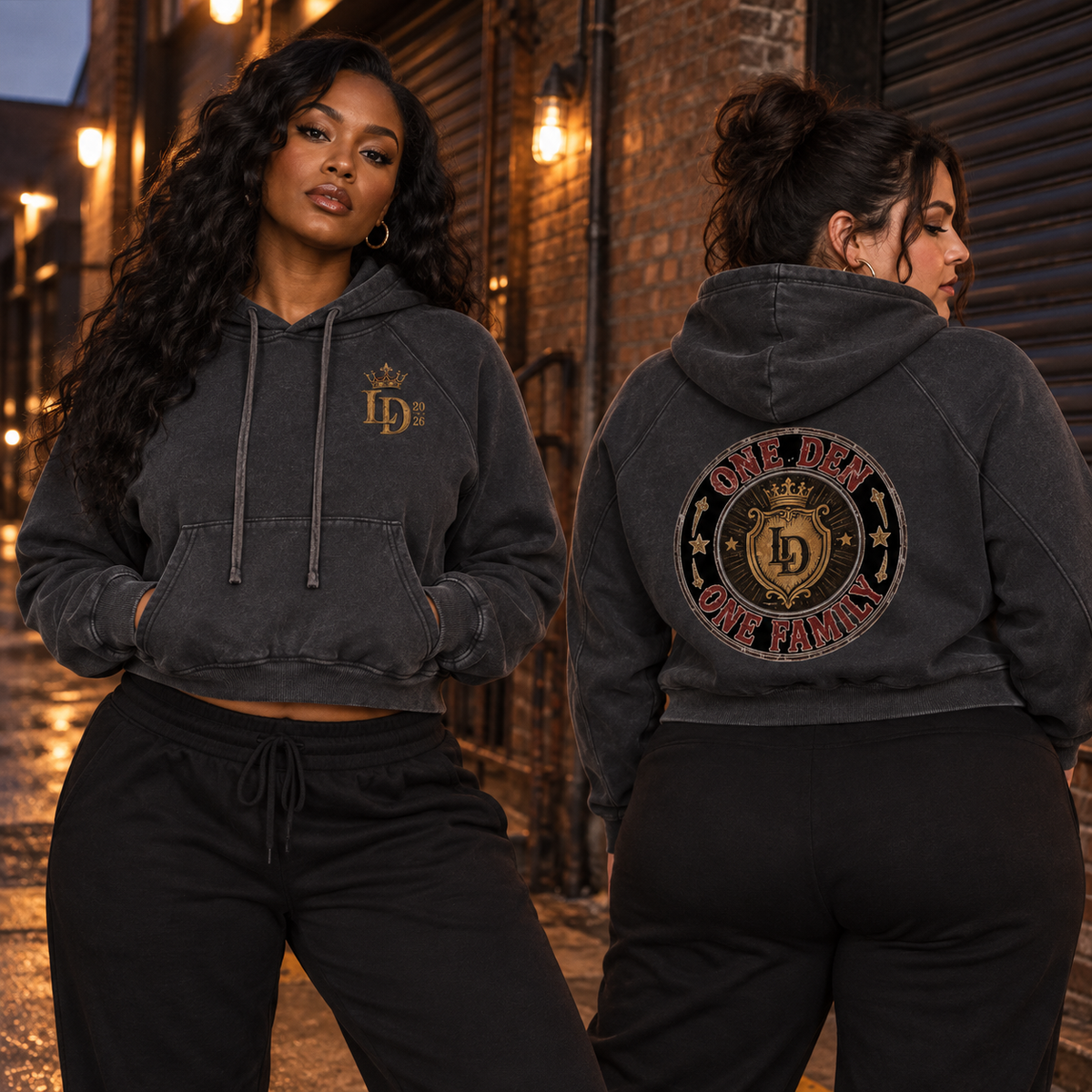 Two women modeling the Lions Den One Den One Family snow-washed cropped hoodie, showing front and back