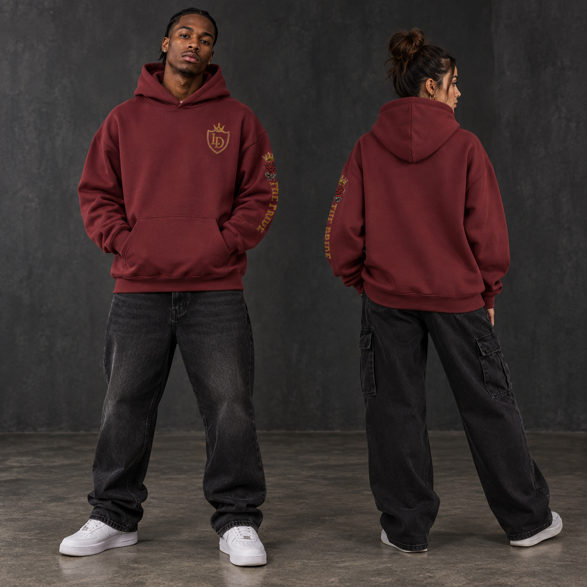 Two models wearing the oxblood Lions Den Royal Shield heavyweight hoodie, shown from the front and back